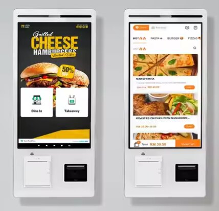 Two wall-mounted self-order kiosks with menu screens, card readers and receipt printers.